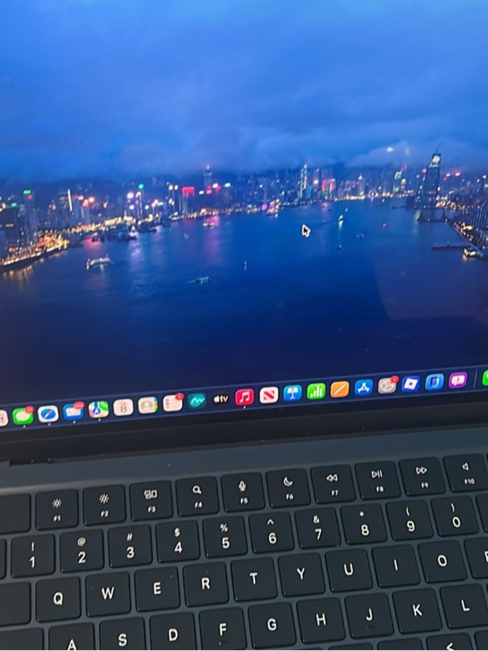 Apple Black MacBook Keyboard with Night City Wallpaper